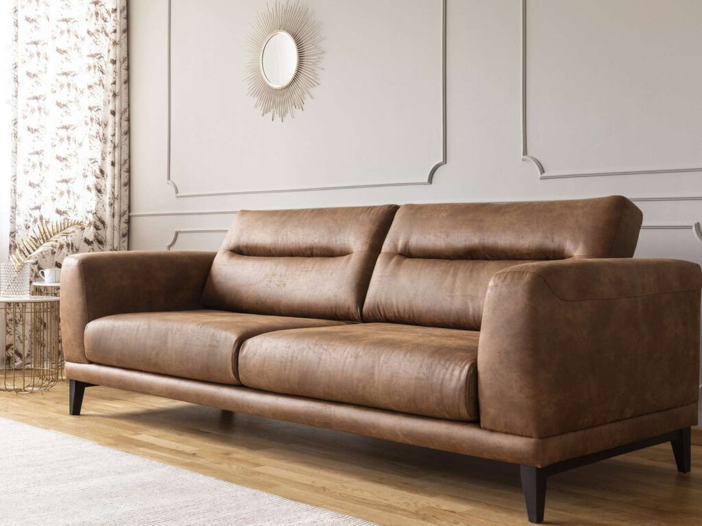 Cleaned leather couch after professional upholstery cleaning, showing restored shine and a fresh, well-maintained appearance